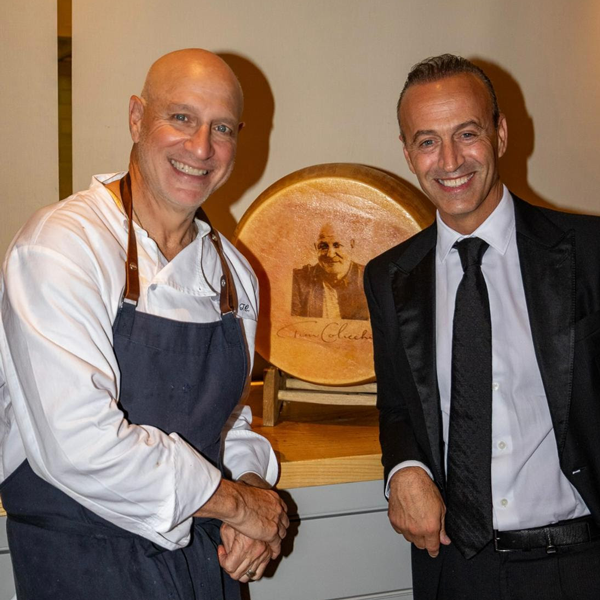 Nicola Bertinelli and Chef Tom Colicchio with a custom wheel of Parmigiano Reggiano at his NYC restaurant Vallata, June 30, 2025